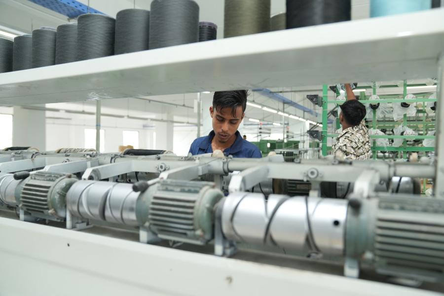 Servo-driven automatic thread tapping machine operating in a manufacturing workshop.